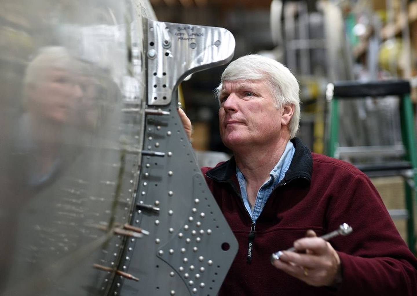 Mike Kellner works on the area where a wing will attach to the B-17 he's rebuilding in his Marengo barn.