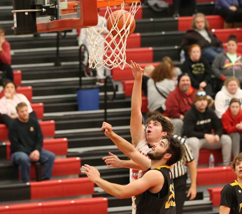 Hall's Hunter Meacher (21) scores on a jump shot over Putnam County's Jackson McDonald (23) during the Colmone Classic on Tuesday, Dec. 6, 2022 at Hall Hight School in Spring Valley.