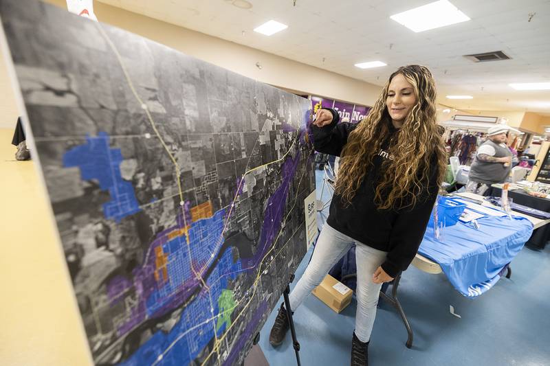 Surf Internet representative Tamia Regan uses a map to point out how the company is expanding Saturday, April 20, 2024 at the Sauk Valley Home Show at Northland Mall in Sterling.