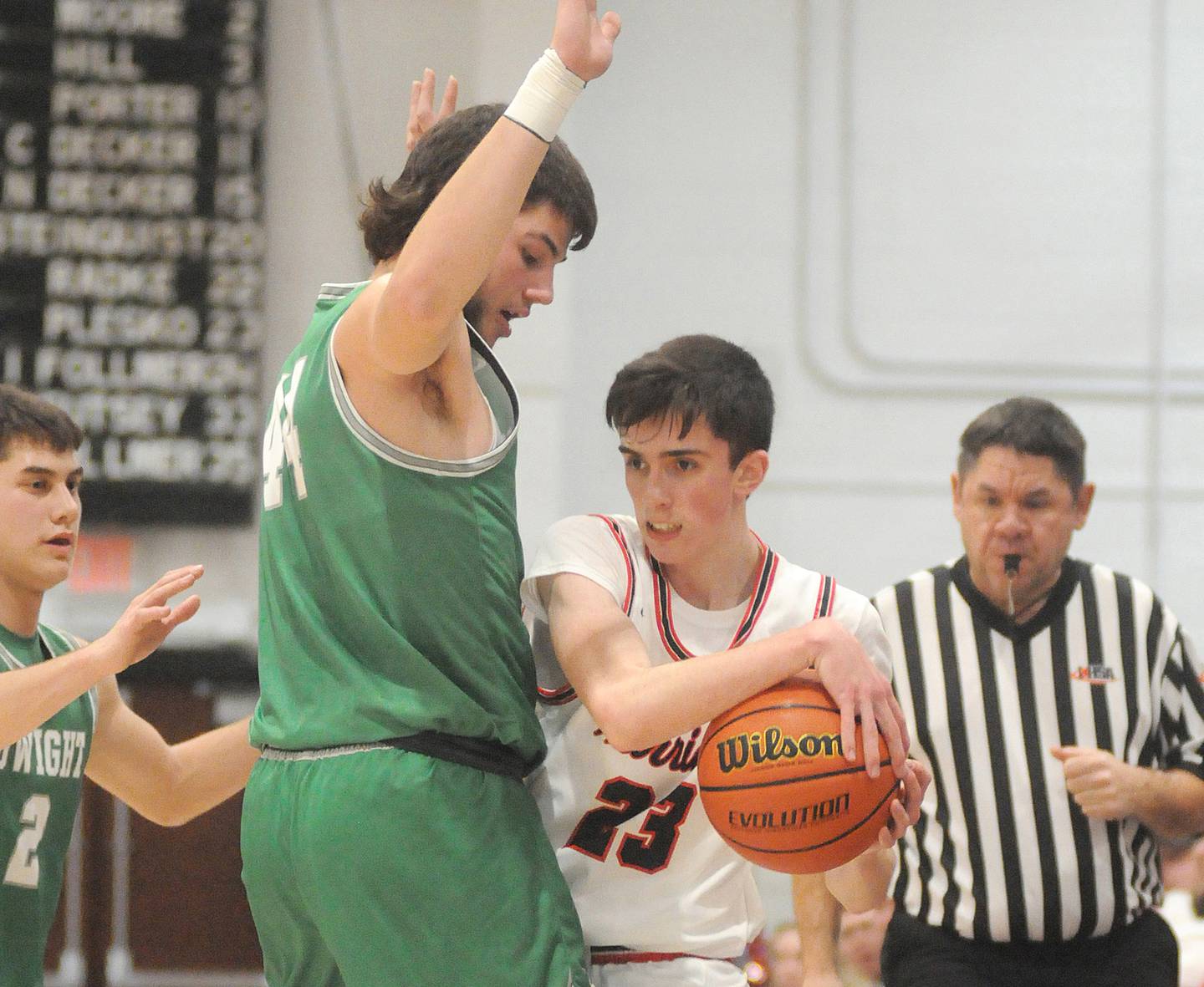 Woodland's Nick Plesko looks to pass around the defense of Dwight's Wyatt Thompson at the Warrior Dome on Friday, Jan. 13, 2023. Thompson posted 28 points, 16 rebounds and three blocks in the Trojans' 51-40 Tri-County Conference win over the host Warriors.