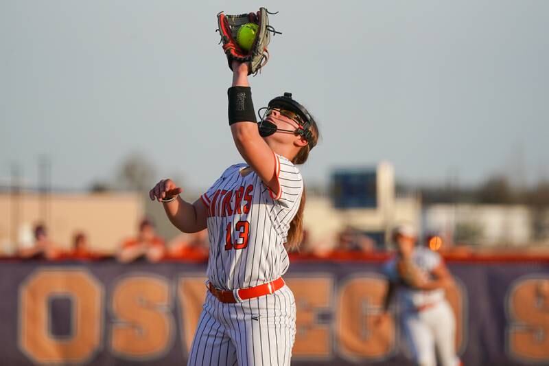 Oswego’s Leah McKenzie (13) catches an infield pop-up for an out during a Southwest Prairie Conference softball game against Minooka at Oswego High School on Wednesday, April 23, 2025.