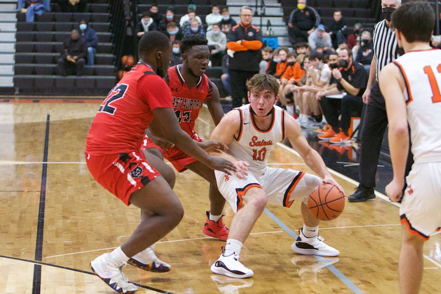 St. Charles East's AJ Gaca is pressured by defense by East Aurora's Enrique Perez JR. (10) and Stephen Dorsey (22) at the 62ND Annual Ron Johnson Thanksgiving Tournament on Nov.22, 2021 in St. Charles.