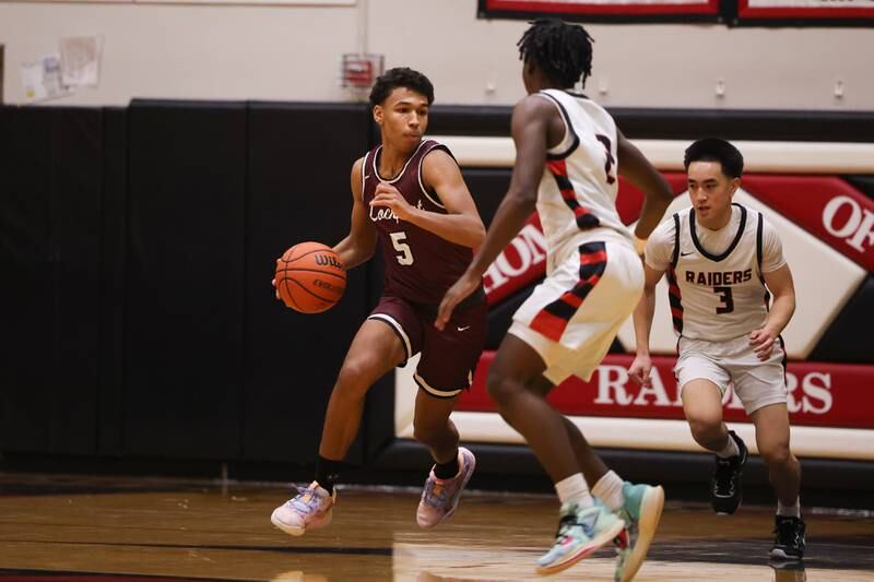 Lockport’s Quinton Hunter takes the ball upcourt against Bolingbrook on Friday, February 10th.