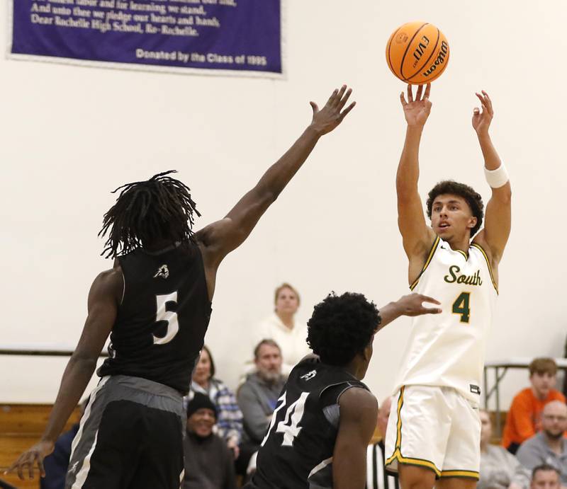 Crystal Lake South's AJ Demirov (right) shoots the ball over Kaneland's Freddy Hassan (left) and Kaneland's Jeffrey Hassan (center) during the IHSA Class 3A Rochelle Sectional championship basketball game on Friday, March 7, 2025, at Rochelle High School.