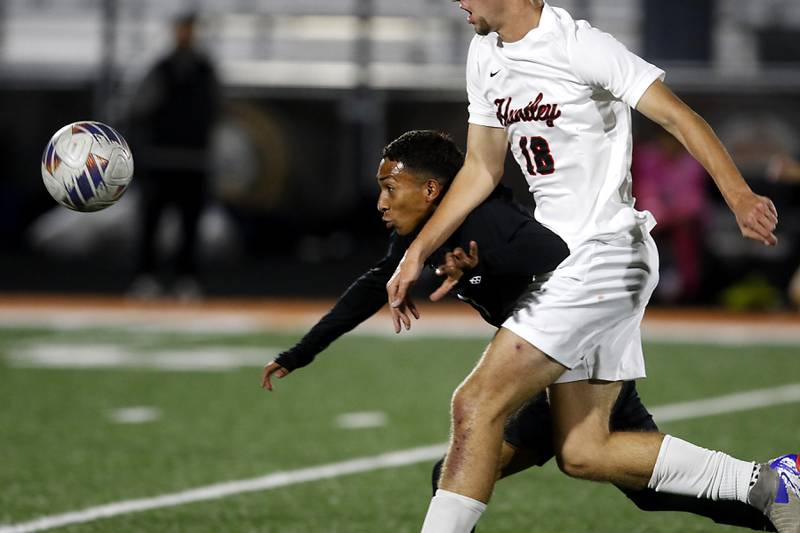 McHenry's Miguel Rondon tries to get to the ball as he battles with \h18\ for position during a Fox Valley Conference boys soccer match on Thursday, Oct. 9, 2025, at McCracken Field in McHenry.