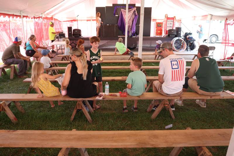 Families take in a magic show at the Will County Fair on Sunday, August 25, 2024 in Peotone.