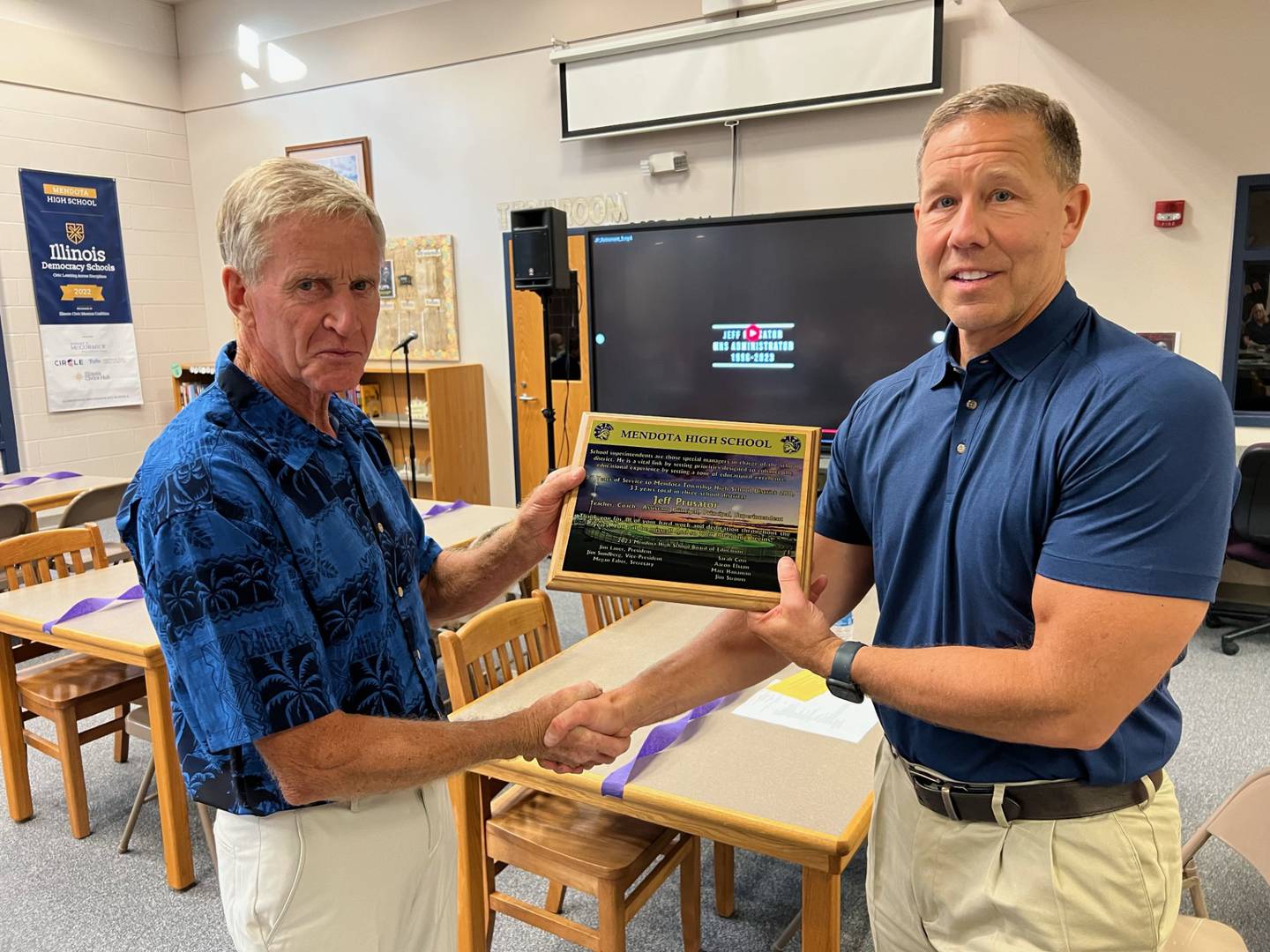 Retiring Superintendent Jeff Prusator (left) receives a plaque Tuesday, June 20, 2023, for his years of service to Mendota High School from Board President Jim Lauer.