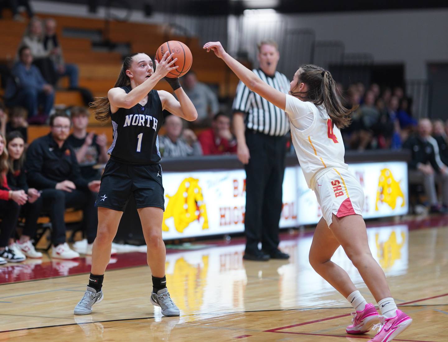 St. Charles North's Laney Stark (1) shoots a three pointer against Batavia's Addi Lowe (4) during a basketball game at Batavia High School on Tuesday, Dec 5, 2023.