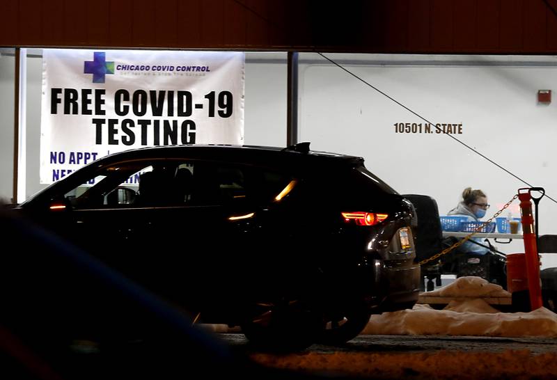 A person waits in their car for the results of a COVID-19 test Monday, Jan. 24, 2022, at Chicago Covid Control testing site in Huntley.