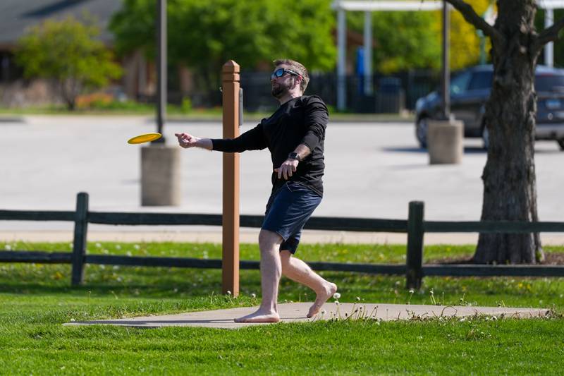 A player throws a disc to start the hole during the Glen Ellyn Park District Ace Race disc golf event at Maryknoll Park in Glen Ellyn, IL on Saturday May 10th, 2025.  The Ace Race is just one of many events the Glen Ellyn Park District holds throughout the year.