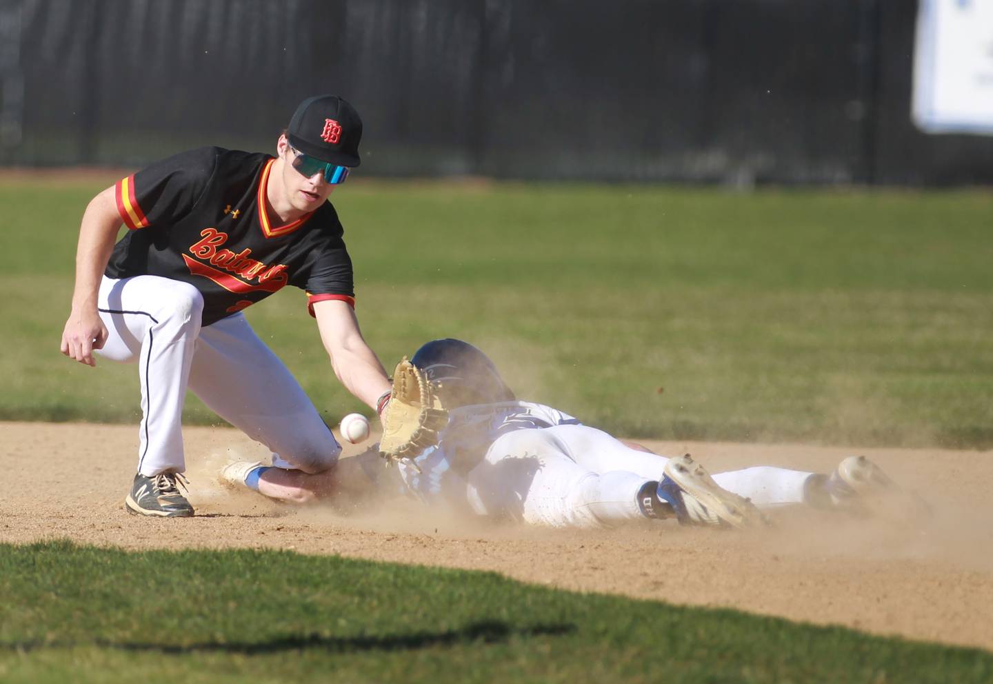 St. Charles North’s Jackson Spring is safe under the glove of Batavia’s Ryan Boe during a game at St. Charles North on Monday, April 15, 2024.