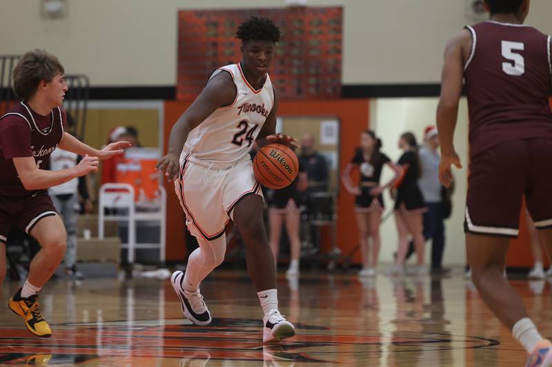 Minooka’s Micah Hamilton works the ball up court against Lockport.