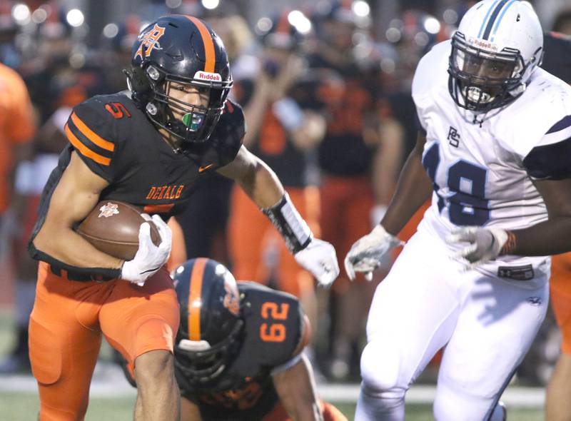 DeKalb running back Toriano Tate is chased by Plainfield South defensive lineman Dhani Hicks during their game Friday, Sept. 3, 2021 at DeKalb High School.