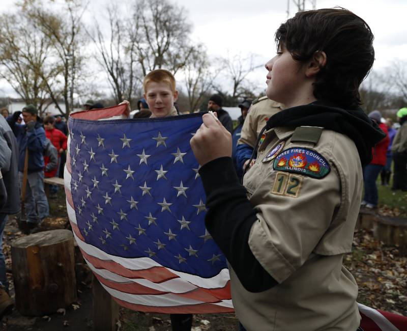Boy Scouts from Troop 12 hold a flag before it is retired during the Annual Veterans Day Scout VFW vigil and  flag retirement ceremony at Overseas VFW Post 1197 in Batavia on Saturday Nov. 5, 2022.