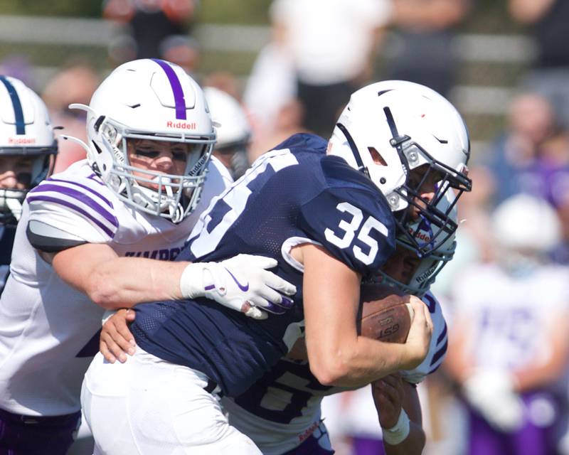 Cary Grove's Michael Massat carries the ball against Hampshire on Saturday Oct. 5,2024 in Cary.