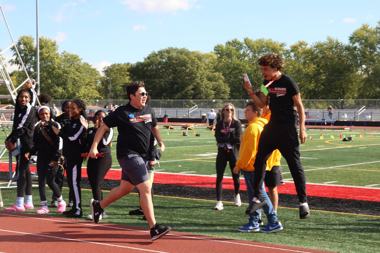 Bradley-Bourbonnais student Derek Otero nears the finish line in first place as a teammate hypes him up during the annual Boilermaker Games, hosted by the Best Buddies club on Wednesday, Oct. 8, 2025.