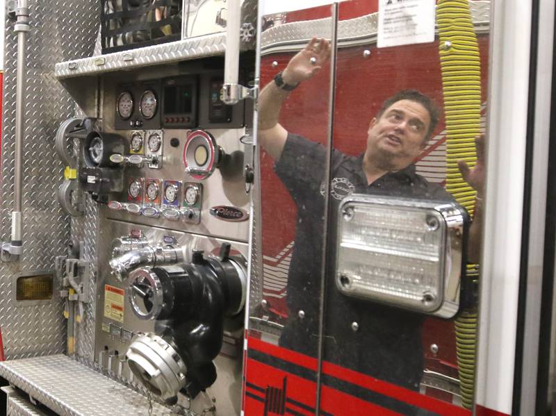 DeKalb firefighter/paramedic Pat Eriksen talks Wednesday, April 17, 2024, at the DeKalb Fire Department Fire house No. 1, about some of the features on one of the ladder trucks.