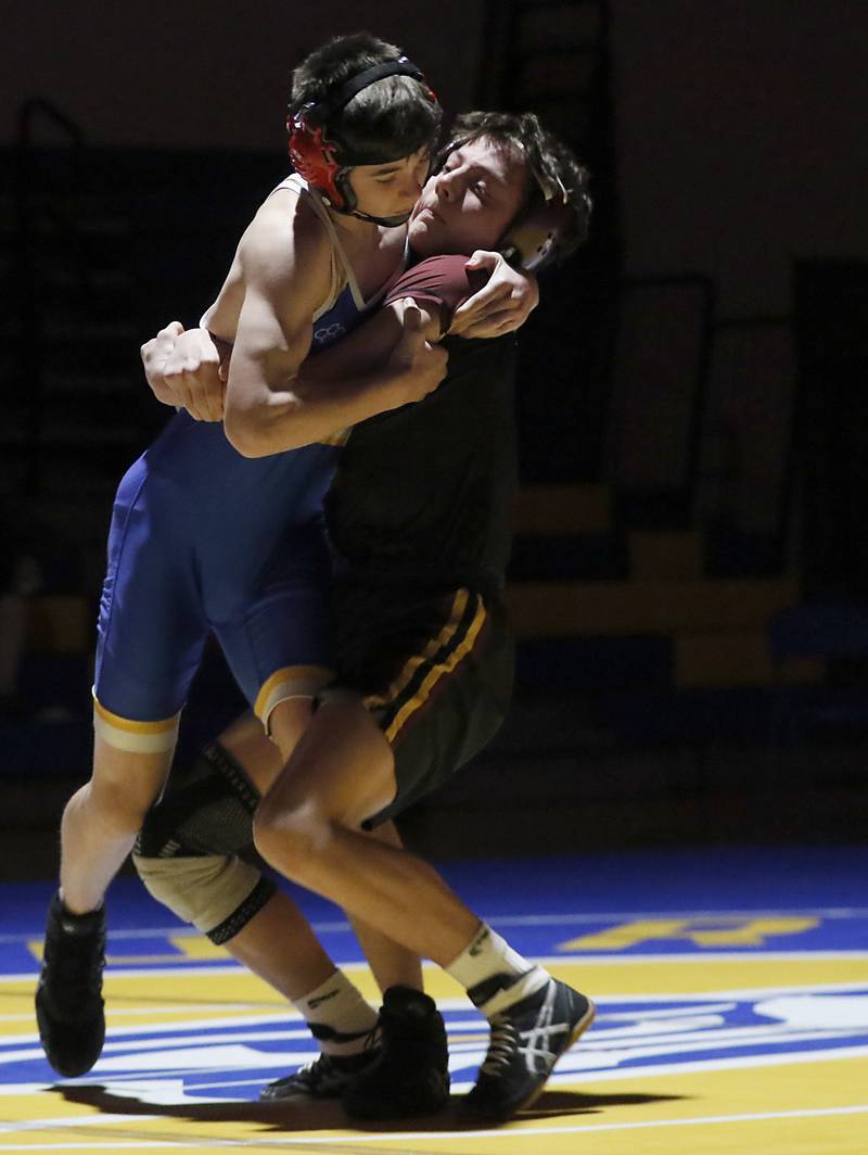Richmond-Burton’s Adam Glauser tries to take down Johnsburg’s Chase Davis in the 120-pound match of a Kishwaukee River Conference wrestling meet on Thursday, Jan. 30, 2025, at Johnsburg High School.