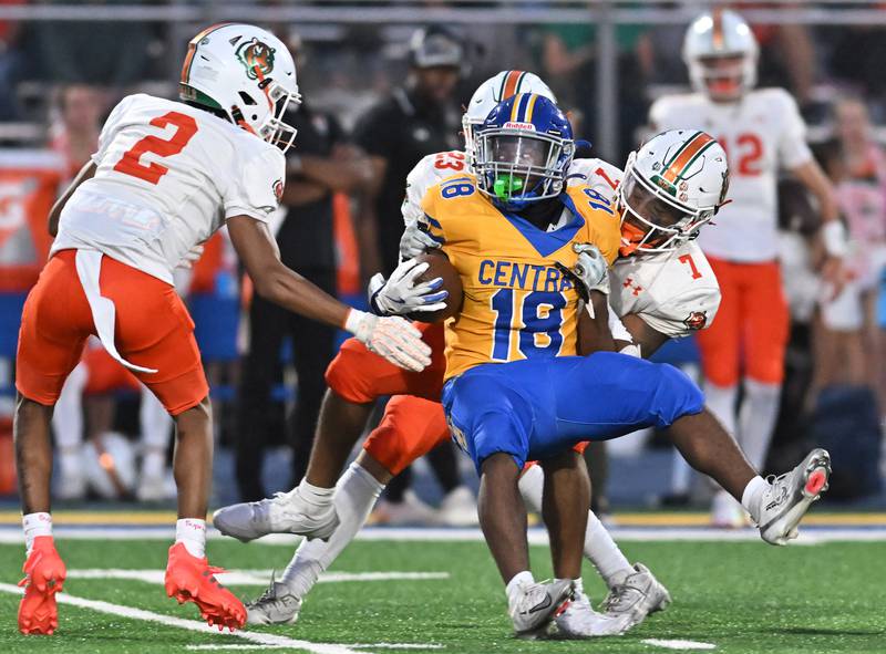 Joliet Central's Tristen Sellers (18) gets tackled by Plainfield East's Jayden Williams (7) during the conference game on Friday, SEP. 12, 2025, at Joliet.