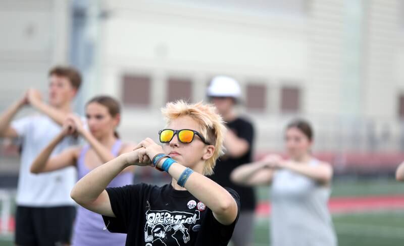 Blue Corley runs through choreography steps with the Batavia High School Marching Band during band camp at the school on Tuesday, July 30, 2024.