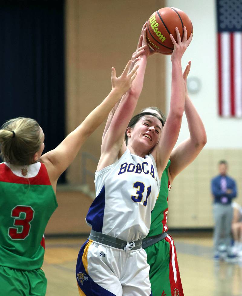 Somonauk's Brynn Pennington grabs a rebound between two LaSalle-Peru players during their game Thursday, Nov. 16, 2023, in the Tim Humes Breakout girls basketball tournament at Somonauk High School.