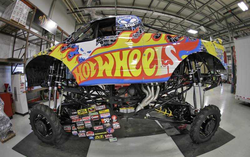 The "Hot Wheels" Monster Truck, shown in this ultra wide angle lens photo, is ready for it's next competition Tuesday, Nov. 25, 2014, in Ellenton, Fla. Feld Entertainment is trying to bring American-style Monster Truck entertainment to other parts of the world. (AP Photo/Chris O'Meara)