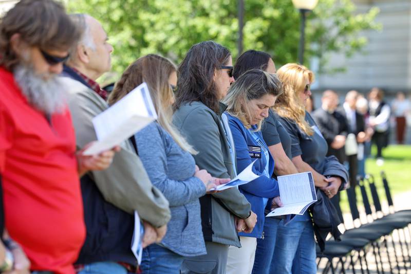 Lyn Stua-Rittmanic, wife of the fallen Bradley Sgt. Marlene Rittmanic, bows her head as the roll call of fallen officers is read during the Kankakee County Law Enforcement Memorial on Thursday, May 14, 2026, at the Kankakee County Courthouse.