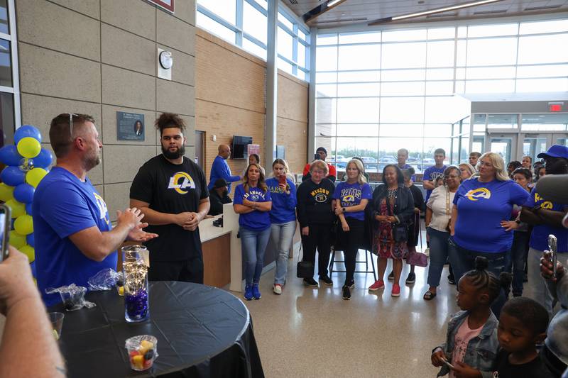 Keagen Trost, a 2019 Kankakee High School grad, second from left, listens along with the crowd as Athletic Director Ronnie WIlcox commends Trost for his hard work and accomplishments during a celebration held for him at the school on May 4, 2026, following him being drafted into the NFL to the Los Angeles Rams.