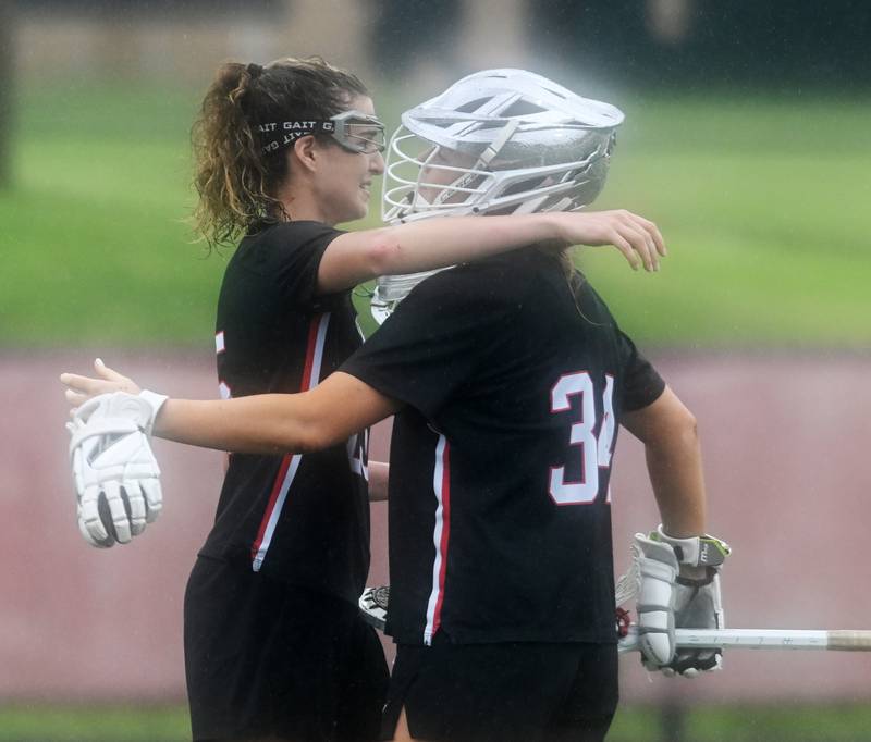Benet Academy’s Shannon Earley, left, hugs goalie Madeline Jensen at the conclusion of the girls state lacrosse title game, which Loyola Academy won 14-5, on Saturday, June 1, 2024 in Hinsdale.