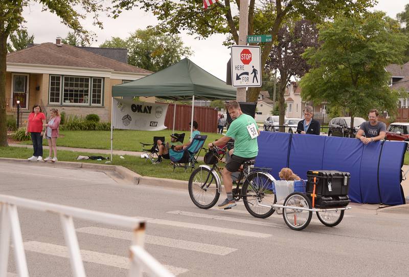 Karl Sokol of Brookfield bikes with his dog Lu Lu while participating in the Family Fun Race during the Cycle Brookfield Criterium on Wednesday, July 24, 2024.
