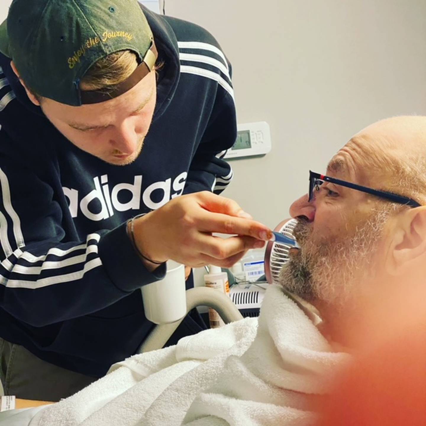 Sean Flannery, son of Tim Flannery, 61, of Joliet, brushes his father's teeth. Tim was severely injured in a motorcycle crash in July 2021 and will most likely never walk, move his arms or care for any of his personal needs again. Big Hearted Bikers is hosting a fundraiser for Flannery from 4 to 8 p.m. on Friday, Nov. 19, 2021 at the Dale Athletic Club, located at 704 Moen Ave. in Rockdale.