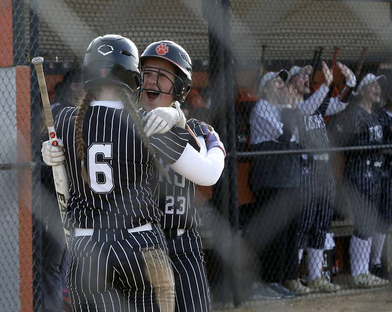 Crystal Lake Central's Harper Wright and Oli Victorine celebrate Wright’s run during a Fox Valley Conference softball game against Huntley on April 7, 2026, at Crystal Lake Central High School.