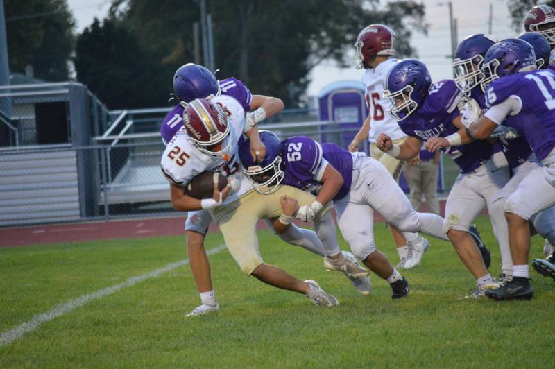 Rochelle's Sebastian Albertson (52) and Tyson Pavlack (11) tackle a Morris player during their junior varsity football game this week. Rochelle won 12-8.