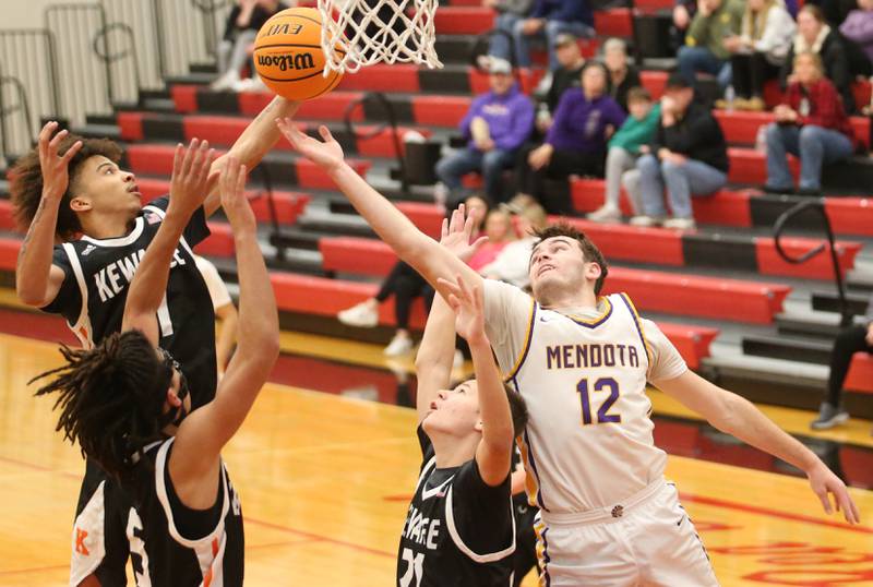 Mendota's Braiden Freeman misses a rebound as Kewanee's Catrelle Reed, Marquelle King and Abram Hicks grab it before him during the 50th annual Colmone Classic on Thursday, Dec. 12, 2024 at Hall High School.