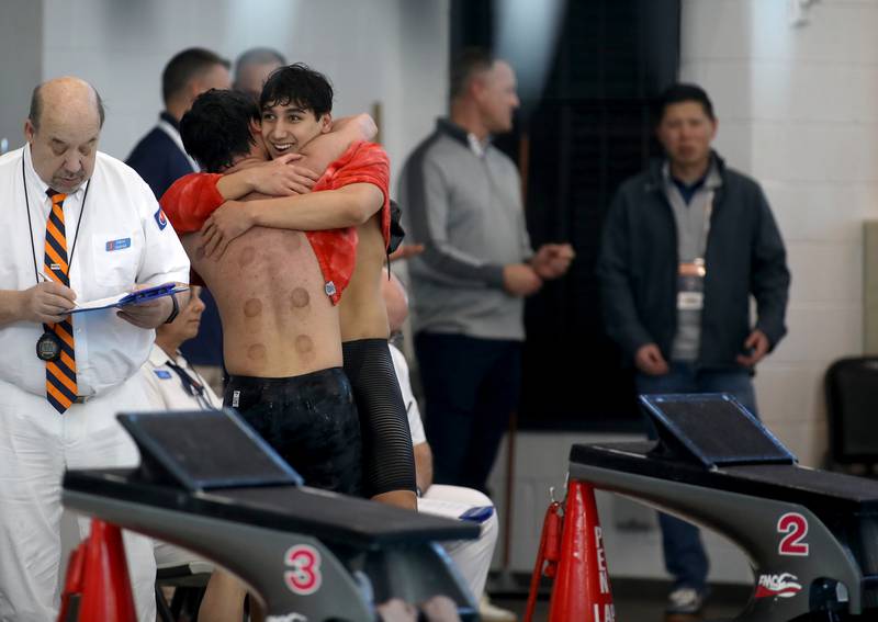Hinsdale Central’s Luke Vatev embraces Hinsdale South’s Parker Chan following the 500-yard freestyle championship heat during the IHSA Boys State Championships on Saturday, March 1, 2025 at the FMC Natatorium in Westmont.