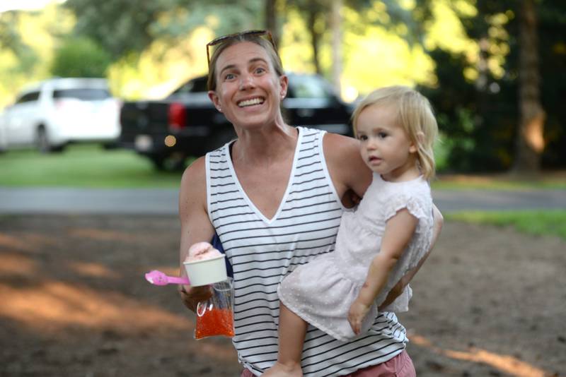 Brooke Etnyre and Maddie head back to their seats after getting ice cream from Just 4 Fun at the Oregon Park District's Concert in the Park on Tuesday, July 15, 2025 at Oregon Park West. E.D. Etnyre Co. sponsored the band Blue Steel for the outdoor concert.
