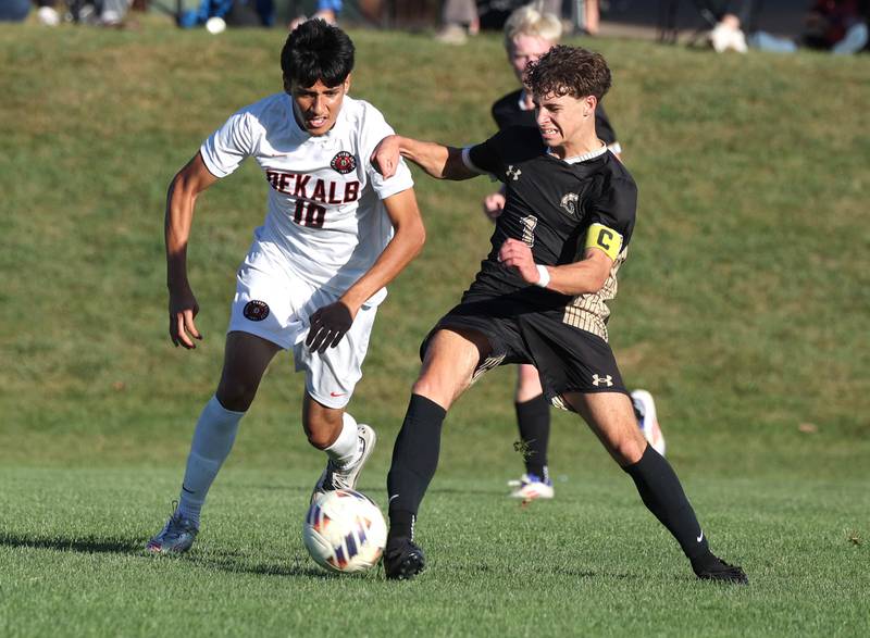 DeKalb's Jorge Correa and Sycamore's Noah Daykin battle for possession during the El Classicorn rivalry game Tuesday, Oct. 7, 2025, at Sycamore High School.