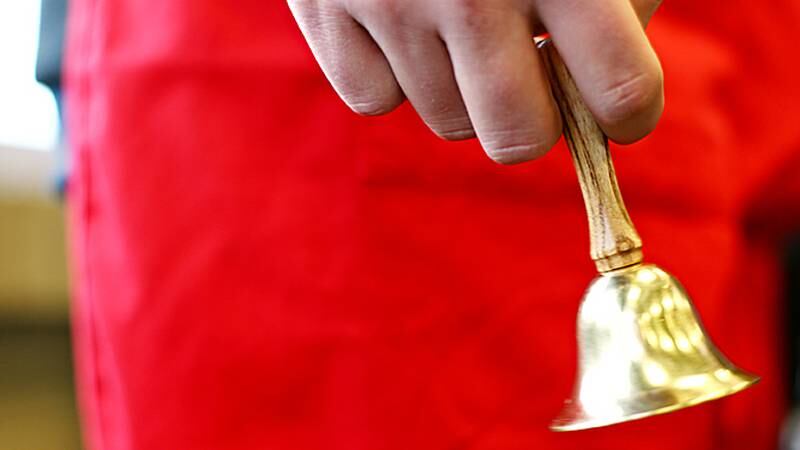 A bell ringer for The Salvation Army stands near the entrance of a DeKalb grocery store in this file photo.