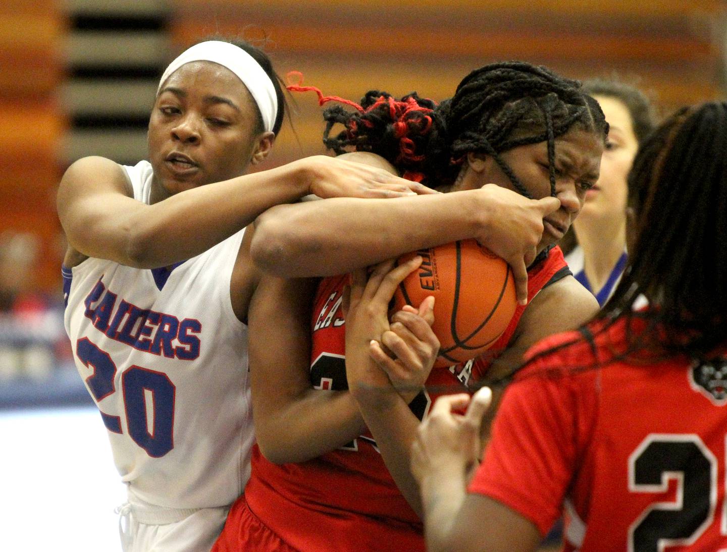 Glenbard South’s Brooklynn Moore (left) and East Aurora’s Anastasia Bellamy (right) get a jump ball call during a game at Glenbard South in Glen Ellyn on Thursday, Jan. 26, 2023.