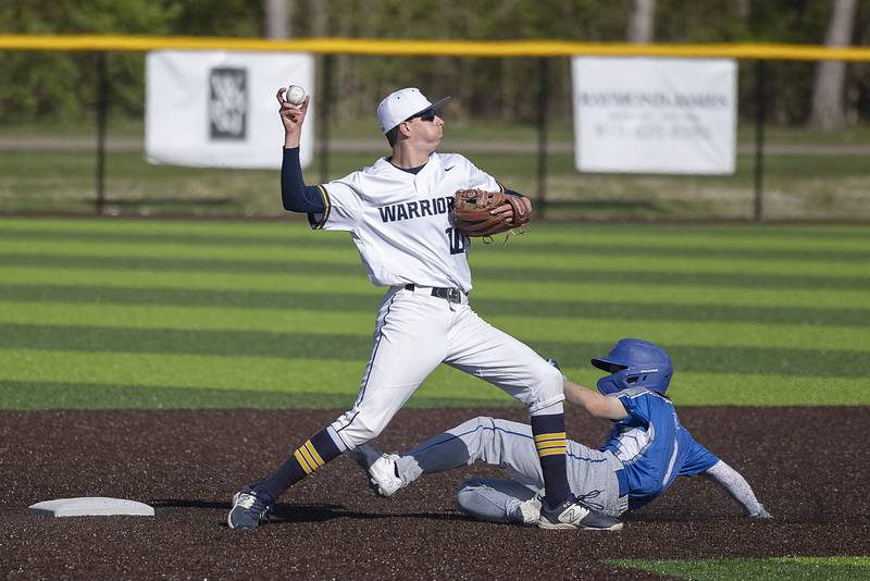Newman’s Garret Matznick works to break up a double play from Sterling’s Trevor Dir Wednesday, May 3, 2023.