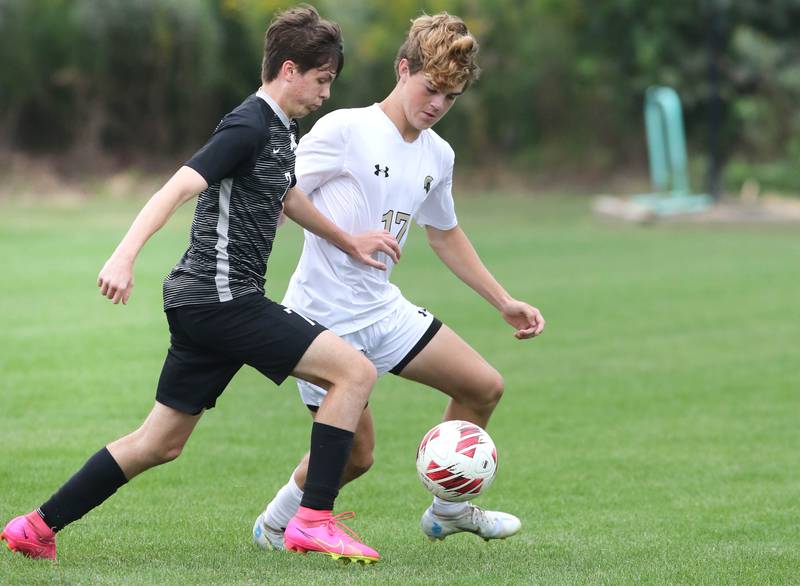 Kaneland's Cameron Guernon (left) and Sycamore's Henry Bumpus race after the ball during their game Wednesday, Sept. 6, 2023, at Kaneland High School in Maple Park.