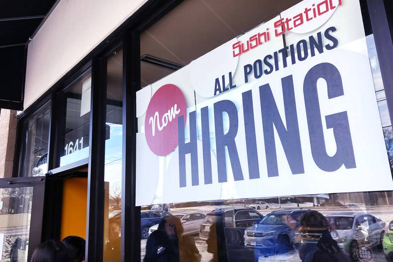 A hiring sign is displayed at a restaurant in Rolling Meadows, Ill., Tuesday, Dec. 27, 2022. (AP Photo/Nam Y. Huh)