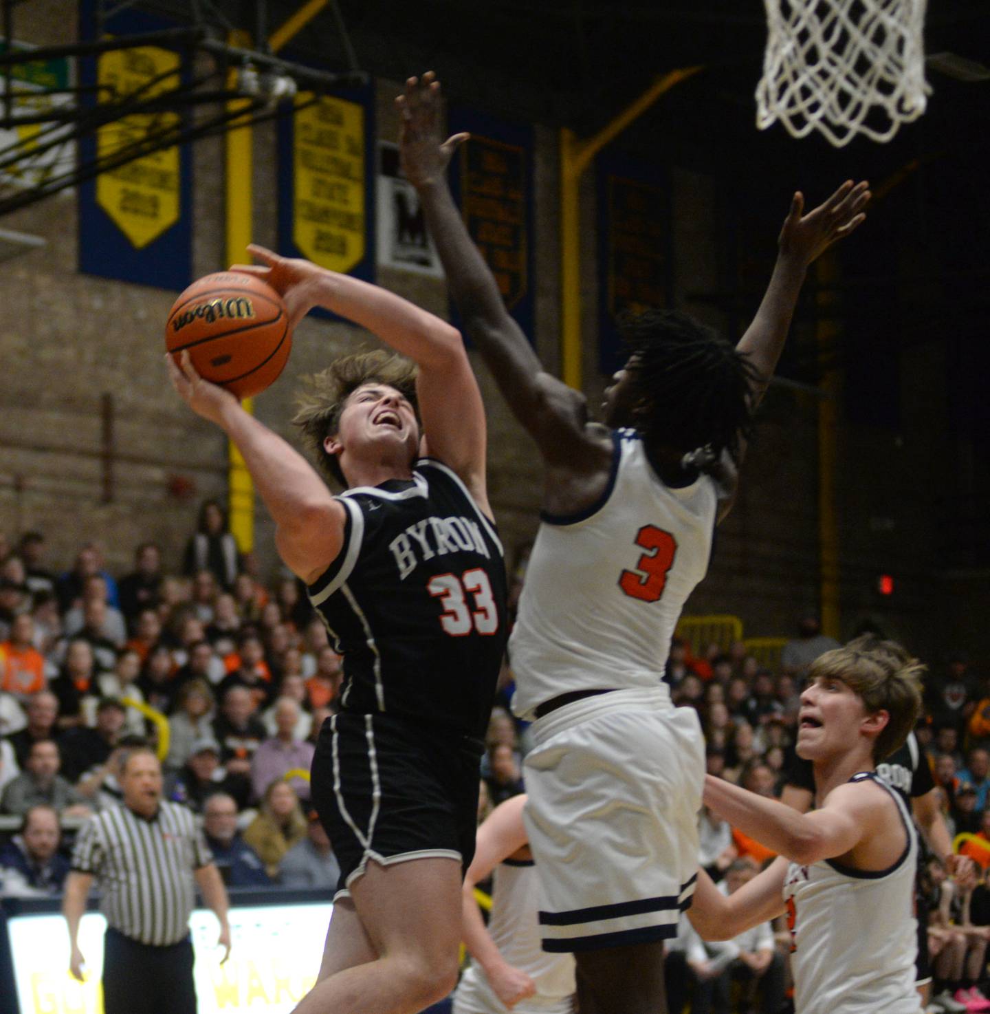 Byron's Caden Considine (33) shoots as Chicago Latin's Ryan Mbouombouo defends at the 2A Supersectional in Sterling on Monday, March 4, 2024. The Tigers beat the Romans 85-71 to advance to the state finals this week in Champaign.