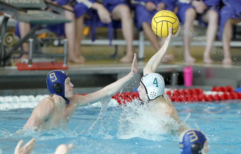 Lyons' Brendan Whelton (9) tries to stop a shot by YorkÕs Tim Jensen (4) during the IHSA State Water Polo consolation match Saturday May 20, 2023 at Stevenson High School in Lincolnshire.