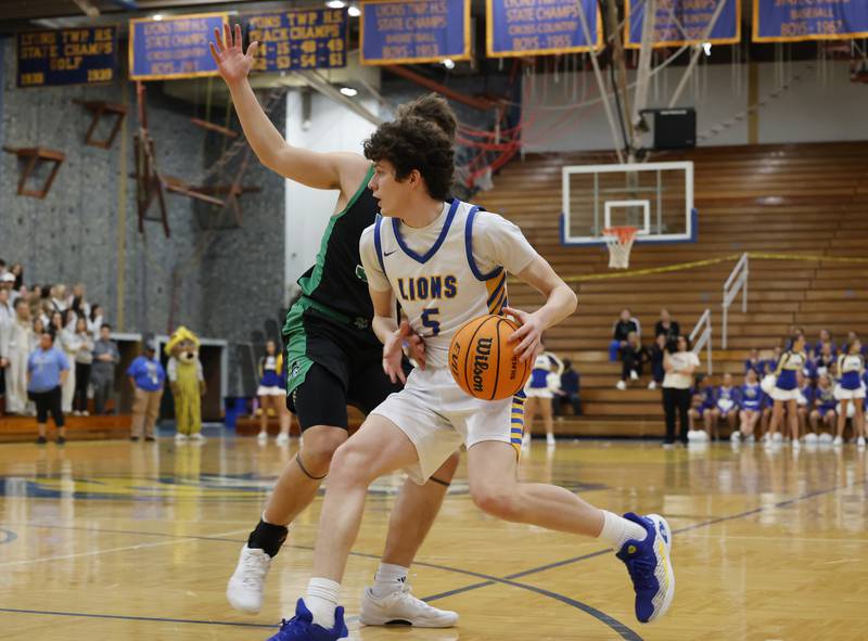 Lyons' Owen Carroll (5) attempts to get past the York defense during a varsity basketball game between York Community and Lyons Township high schools on Friday, Jan. 9, 2026 in La Grange.
