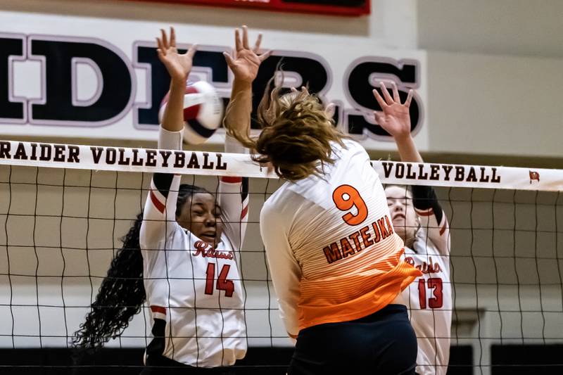 Minooka's Charlotte Matejka goes for a kill as Bolingbrook's Ayanna Davis and Faith Fisher attempt to block during a varsity volleyball game against at Bolingbrook on Sept. 25, 2025.