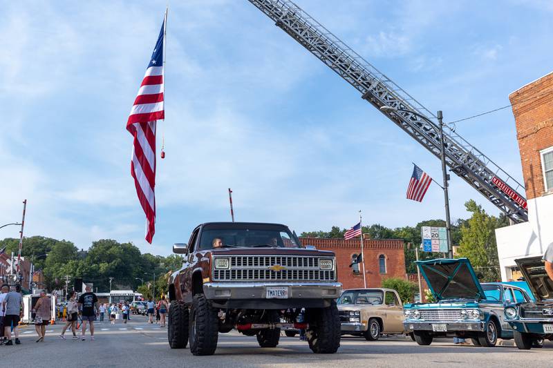 A truck drives down the street at the 20th annual Cruise Night on Friday, August 8, 2025, on Main Street in Marseilles.