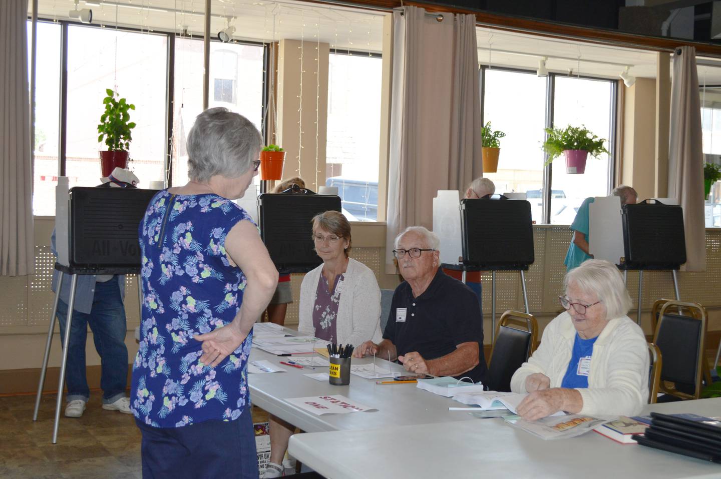 Ogle County election judges Merla Brooks, right; David Bucher, center; and Ellen Ebert work together to provide a voter with their ballot during the June 28 primary elections. The three judges were stationed at the Polo Area Senior Services Center in downtown Polo.