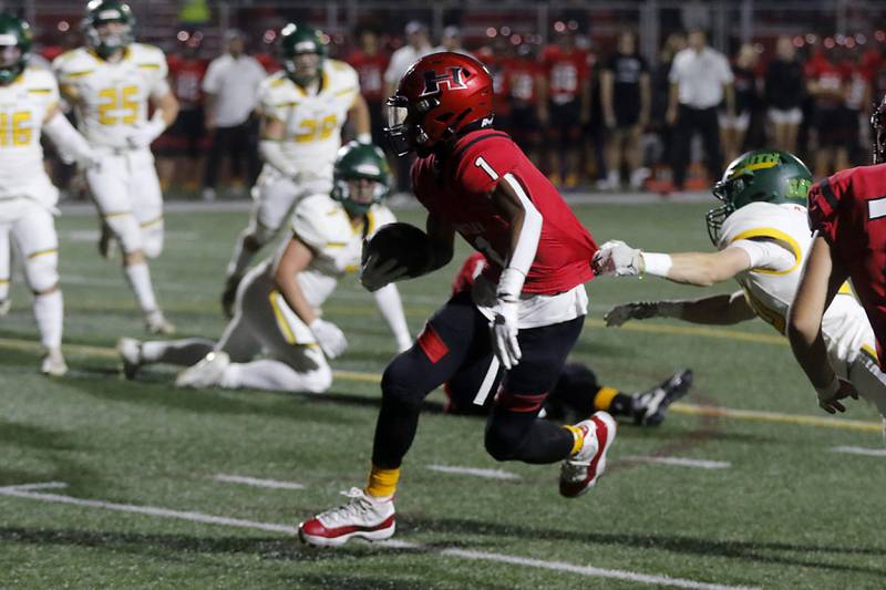 Huntley's Bryce Walker runs out of the grasp of Crystal Lake South's Brady Skirpan to score a touchdown during a Fox Valley Conference football game on Friday, Sept. 29, 2023, at Huntley High School.
