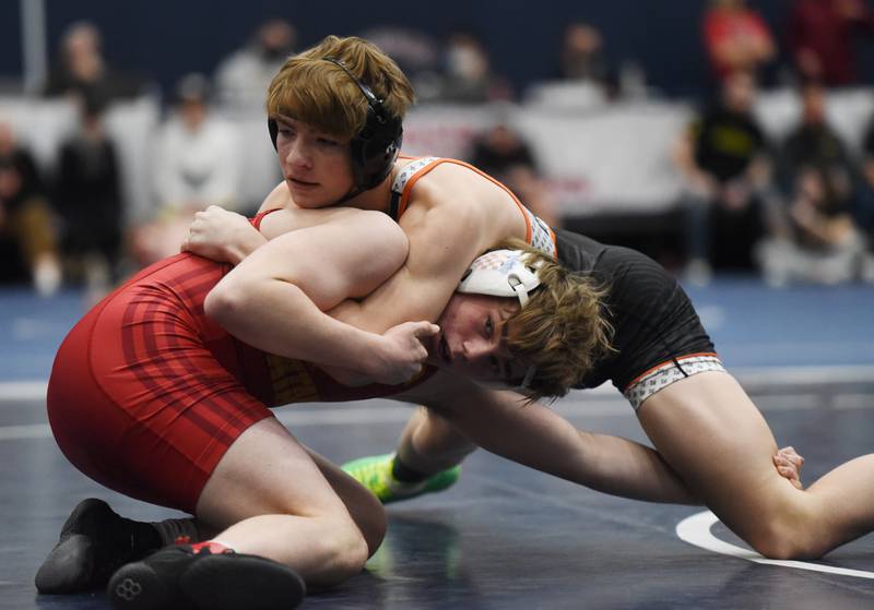 St. Charles East’s Gavin Connolly, top, wrestles Batavia’s Cael Andrews in a 145-match during the semifinals of the Conant wrestling sectional in Hoffman Estates Saturday.